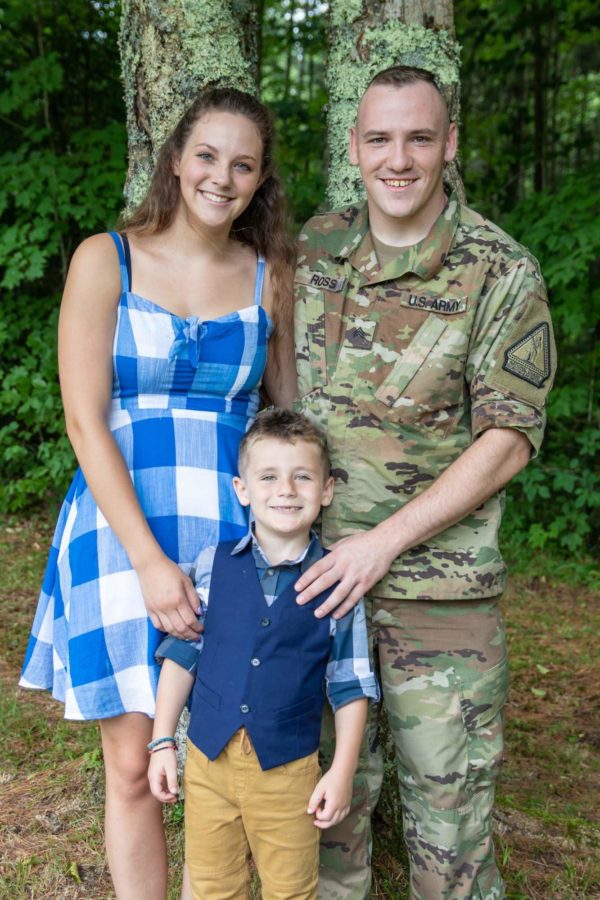 Tyler in military uniform taking a family photo.