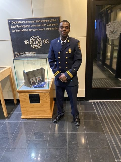 Rhodell standing in his department in uniform.