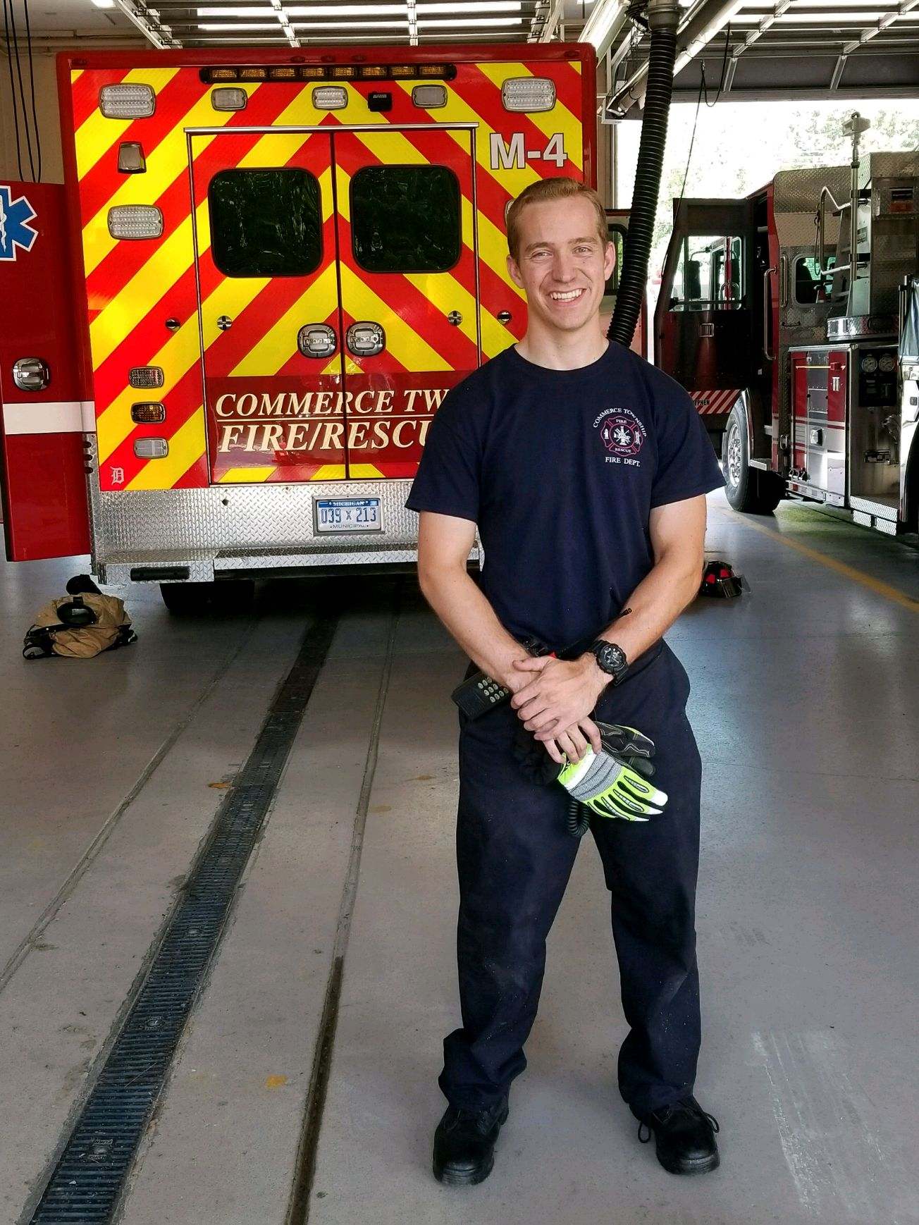 Tyler_Caswell_GA_Sep_2020 Tyler standing behind a fire truck posing for a photo.